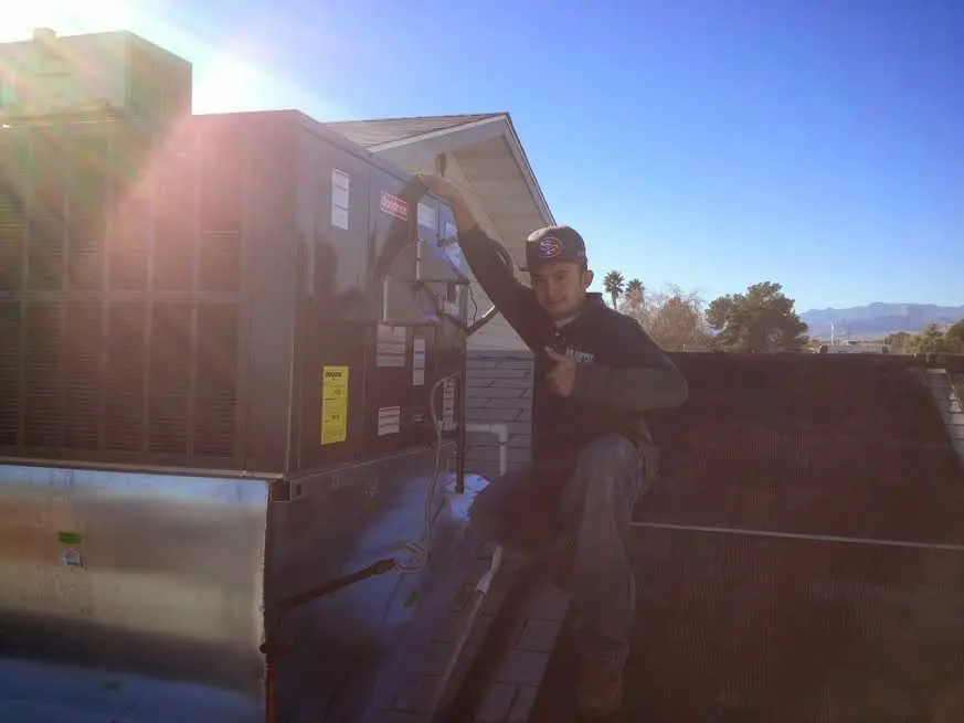 HVAC technician performing Heat Pump Repair on a rooftop unit in Sedro-Woolley